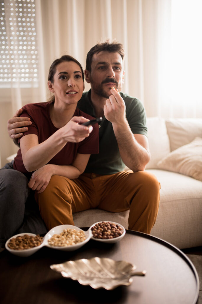 Young couple watching favourite movie