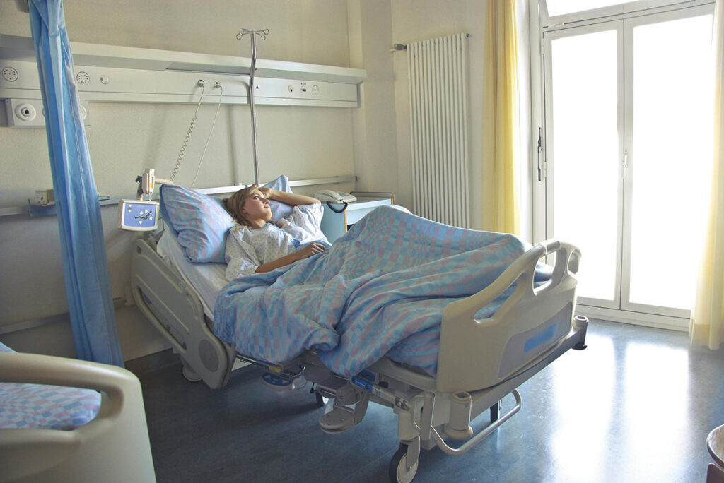 Woman Lying in Hospital Bed