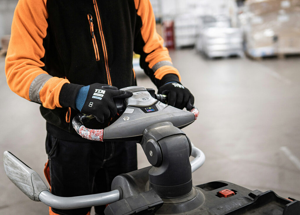 Worker driving a fork lift